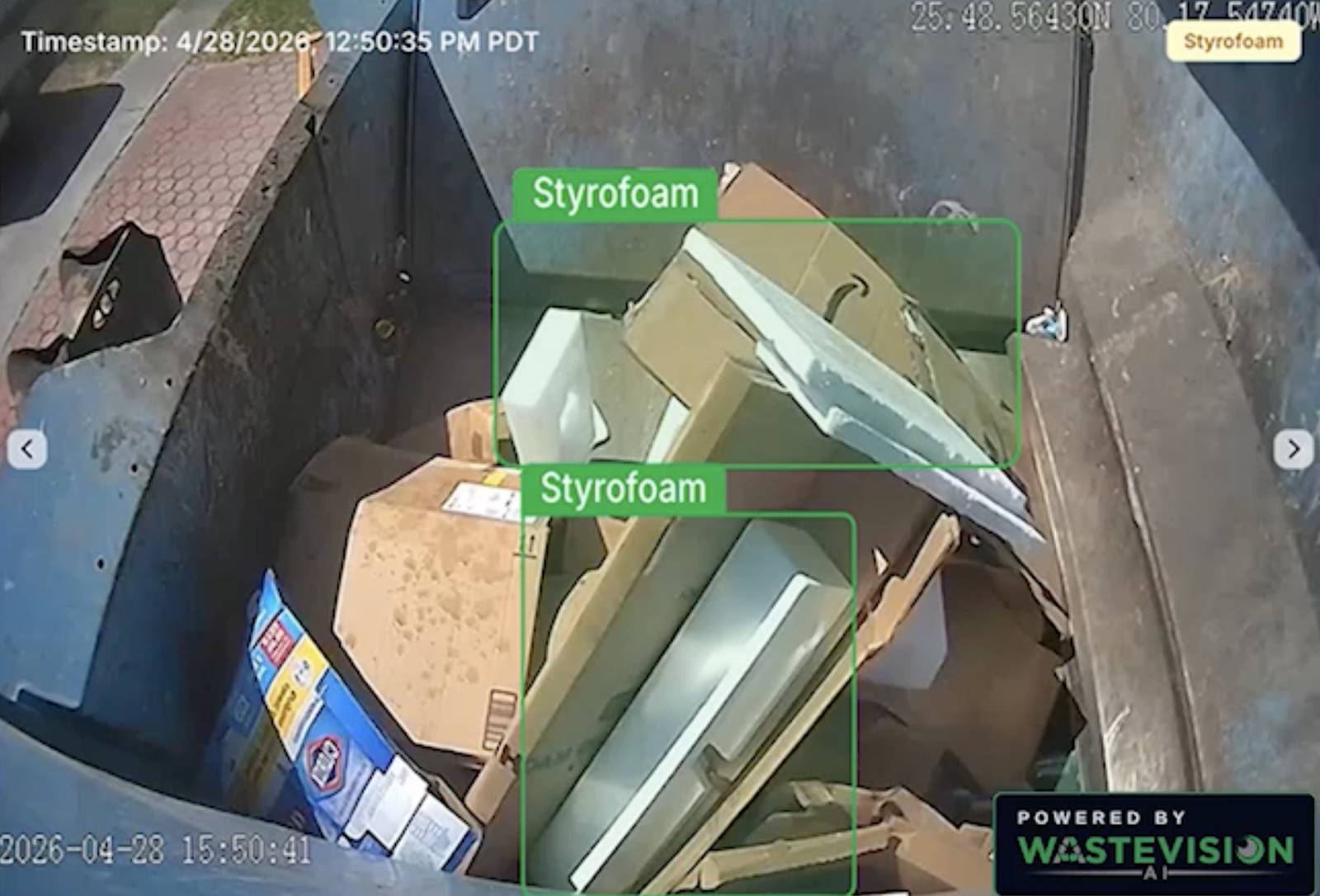 WasteVision AI contamination detection event inside a recycling cart, with two pieces of styrofoam boxed and labeled among cardboard, plus a timestamp and GPS coordinates
