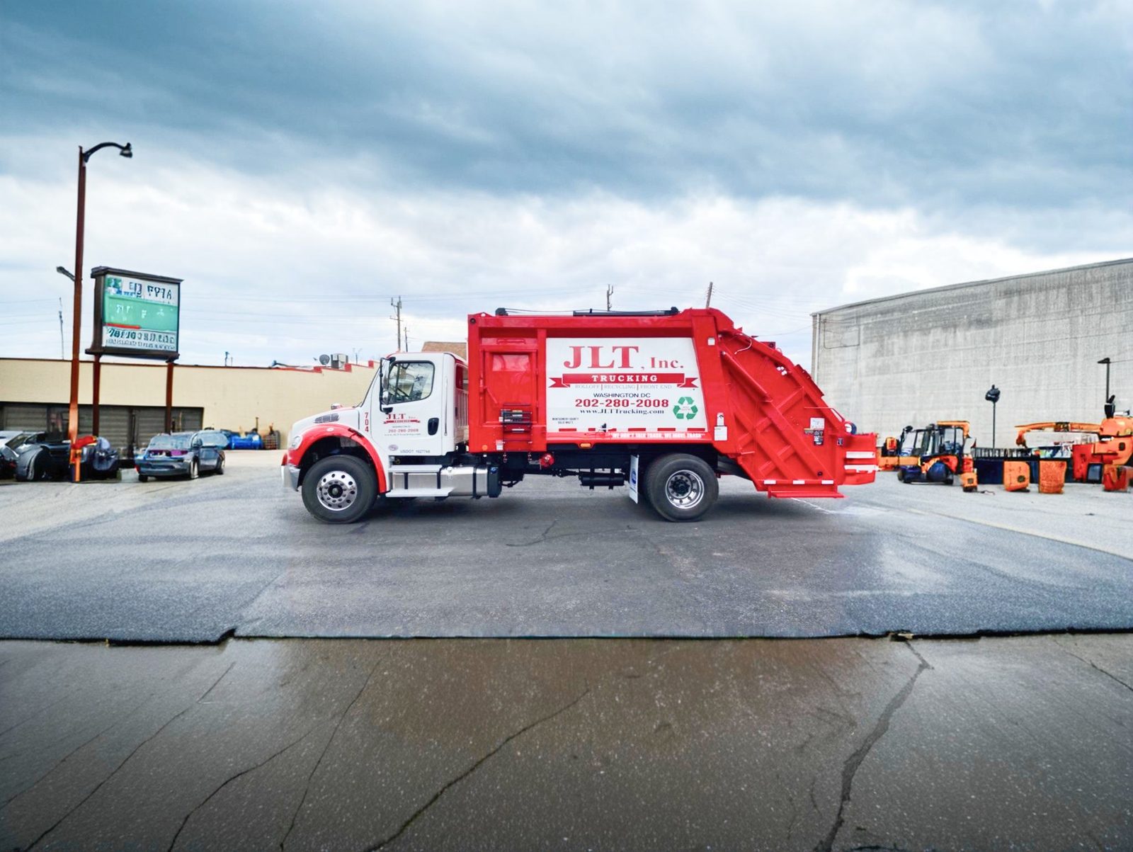 JLT Inc. waste collection truck operating in Washington, DC