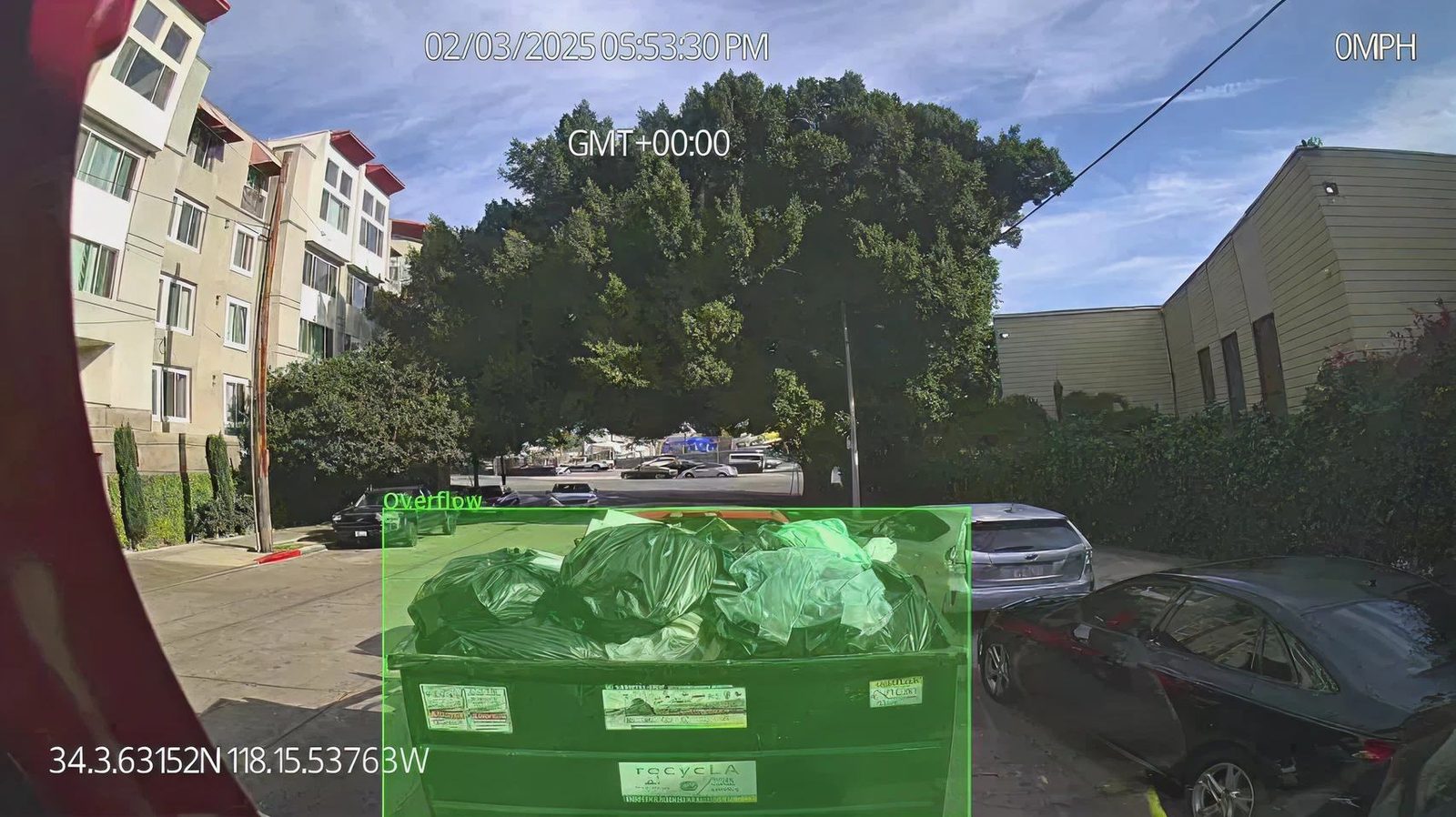 WasteVision AI detecting an overflowing commercial dumpster with bounding box overlay
